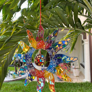 Decoration for the house in the shape of a sun in rainbow colors